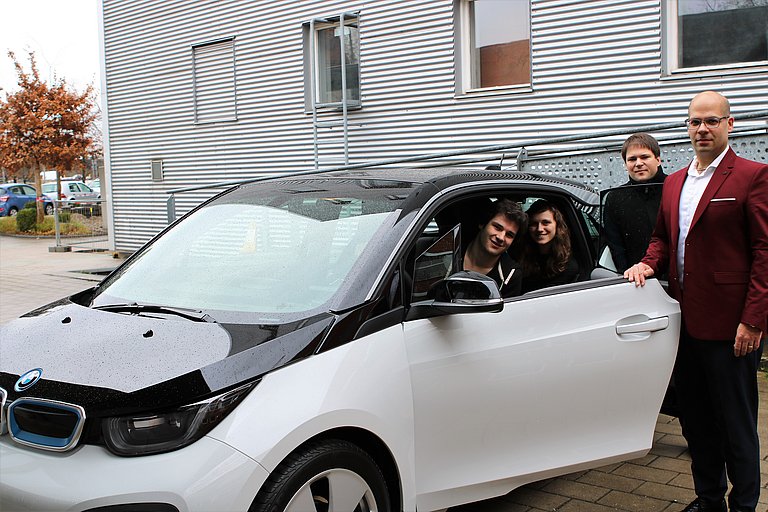 The research group with the BMW i3 research vehicle